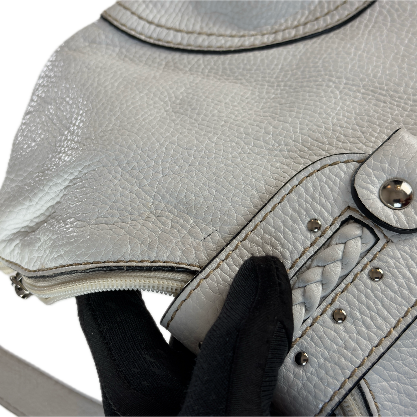 Vintage Coccinelle white pebbled leather hobo bag featuring braided leather details and silver stud hardware.