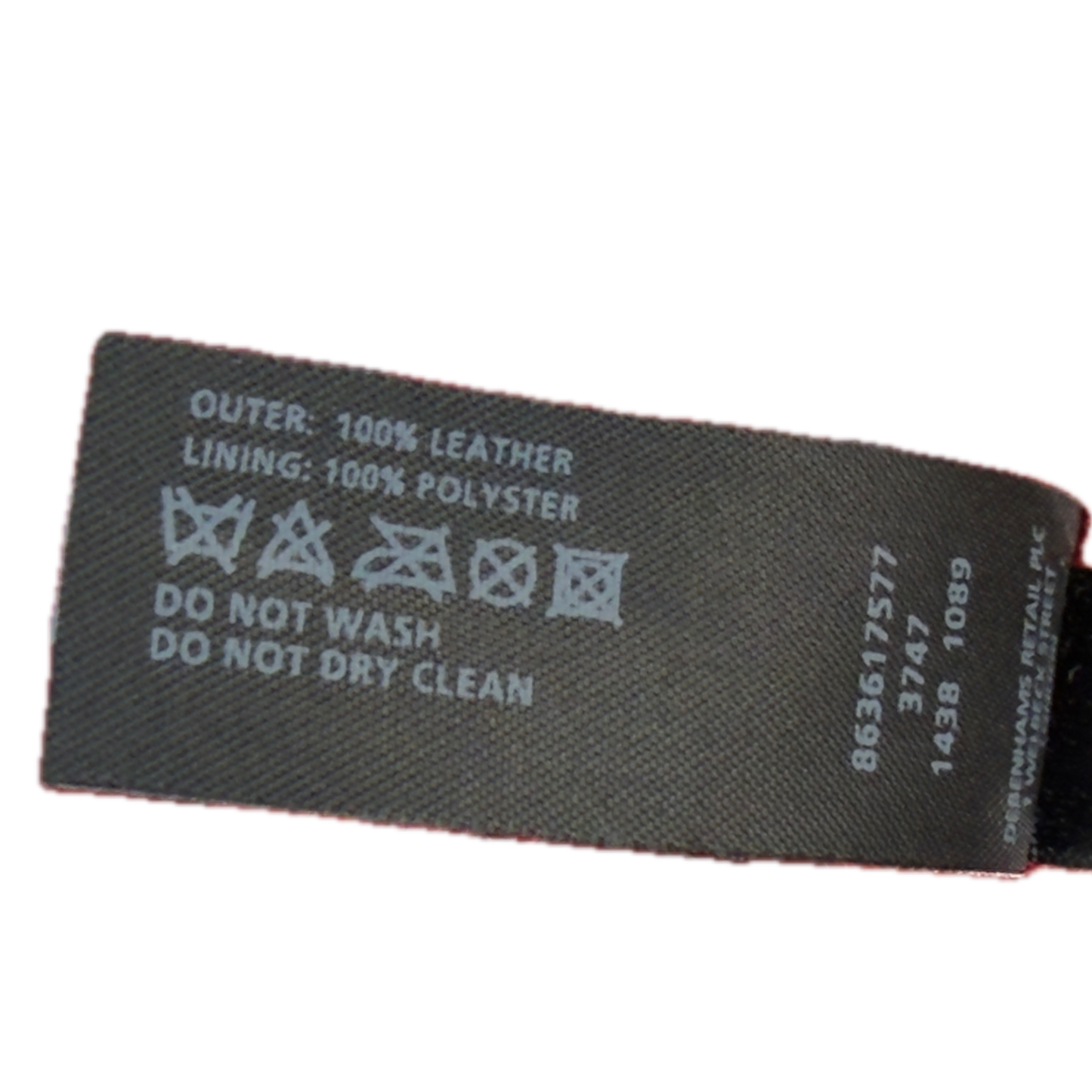 A close-up of a black fabric product label with white printed text and care symbols, including 'OUTER: 100% LEATHER', 'LINING: 100% POLYESTER', and 'DO NOT WASH DO NOT DRY CLEAN'.