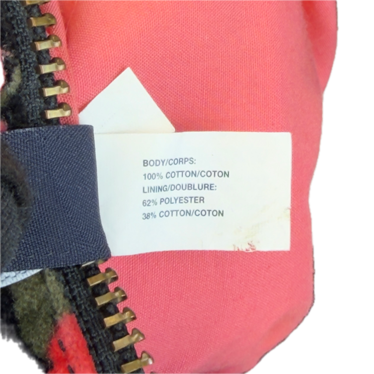 Close-up detail of the internal white garment tag on a vintage GAP velour bag, confirming its 100% cotton composition.