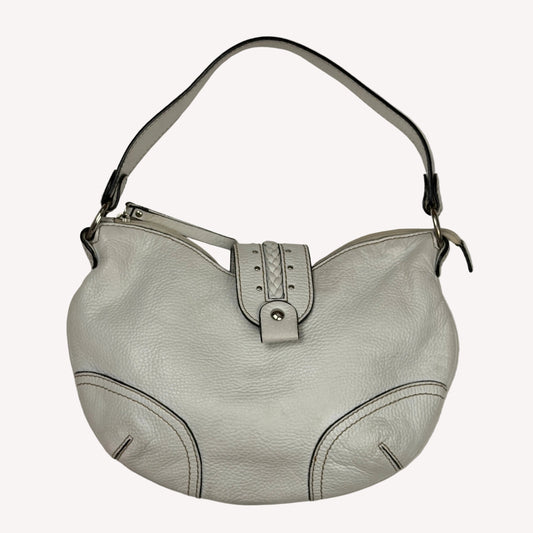 Vintage Coccinelle white pebbled leather hobo bag featuring braided leather details and silver stud hardware.