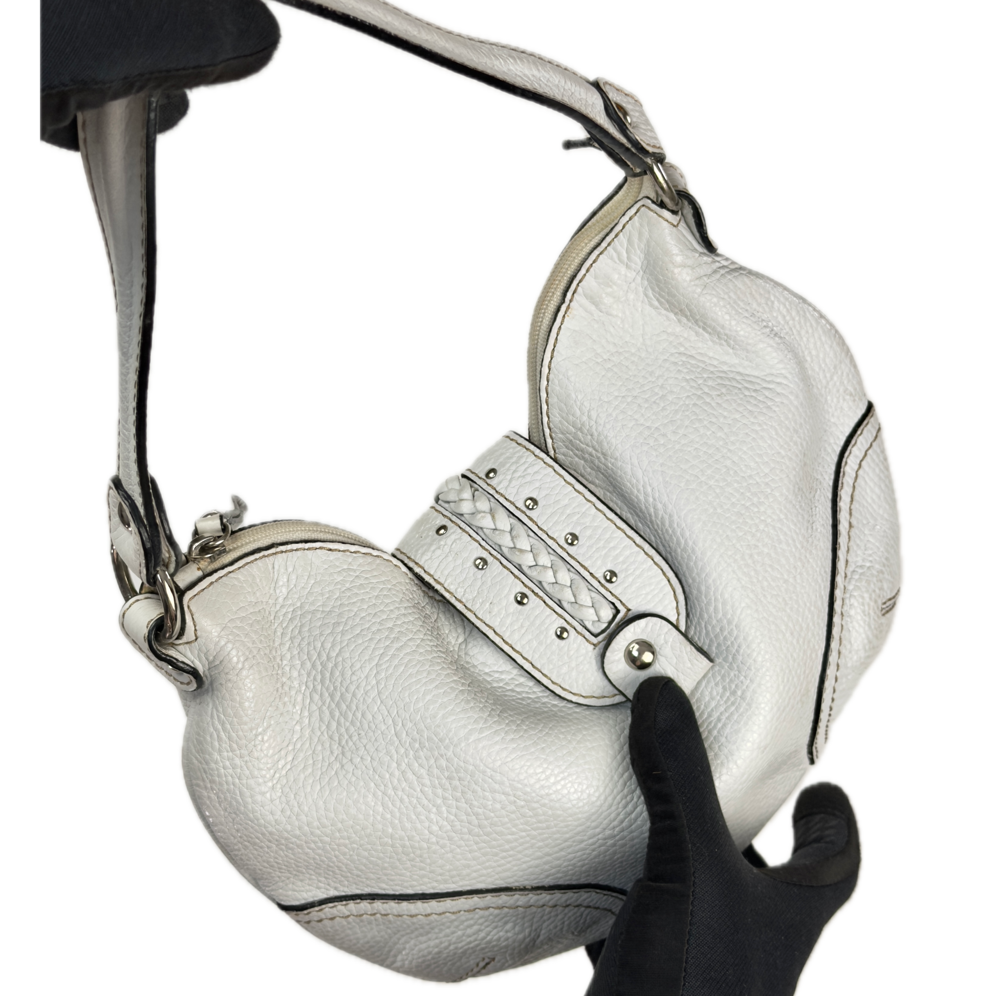 Vintage Coccinelle white pebbled leather hobo bag featuring braided leather details and silver stud hardware.