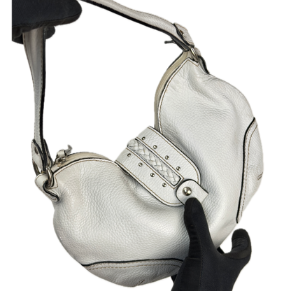 Vintage Coccinelle white pebbled leather hobo bag featuring braided leather details and silver stud hardware.