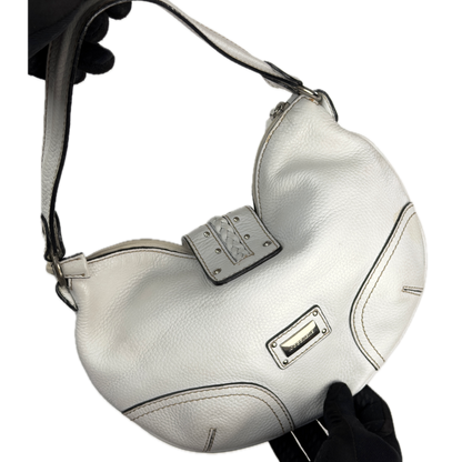 Vintage Coccinelle white pebbled leather hobo bag featuring braided leather details and silver stud hardware.
