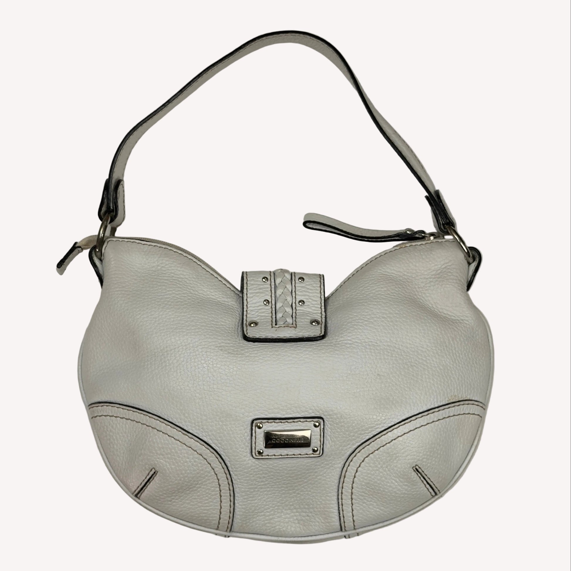 Vintage Coccinelle white pebbled leather hobo bag featuring braided leather details and silver stud hardware.