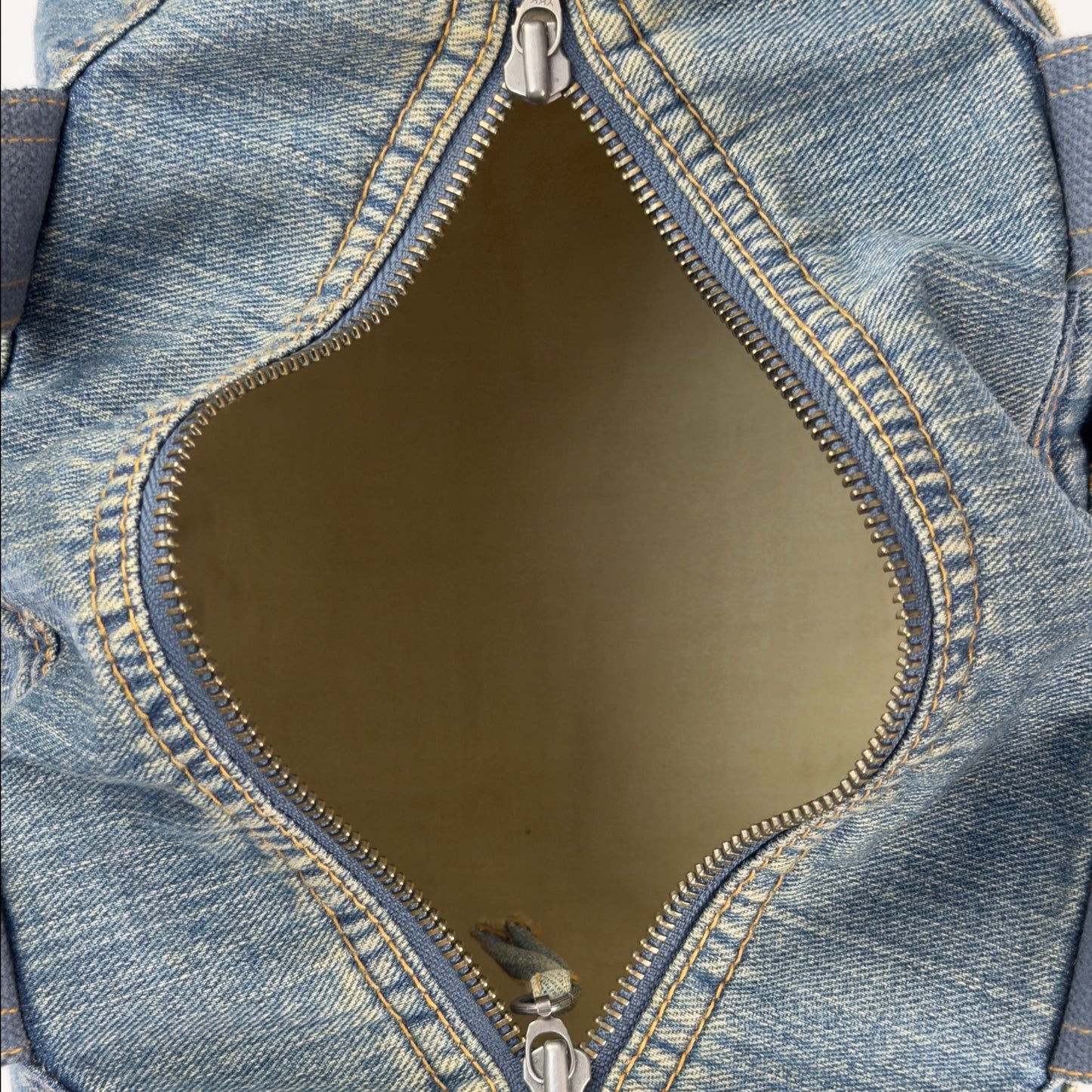 Vintage early 2000s FCUK denim top handle bag featuring a mustard yellow embroidered logo and two front jean pockets.