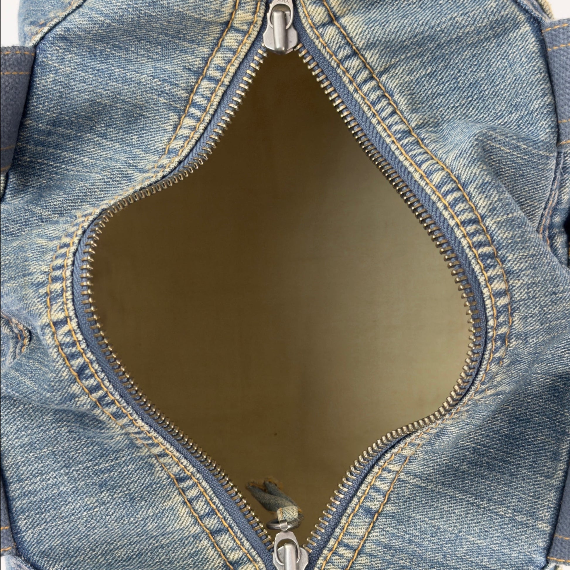 Vintage early 2000s FCUK denim top handle bag featuring a mustard yellow embroidered logo and two front jean pockets.