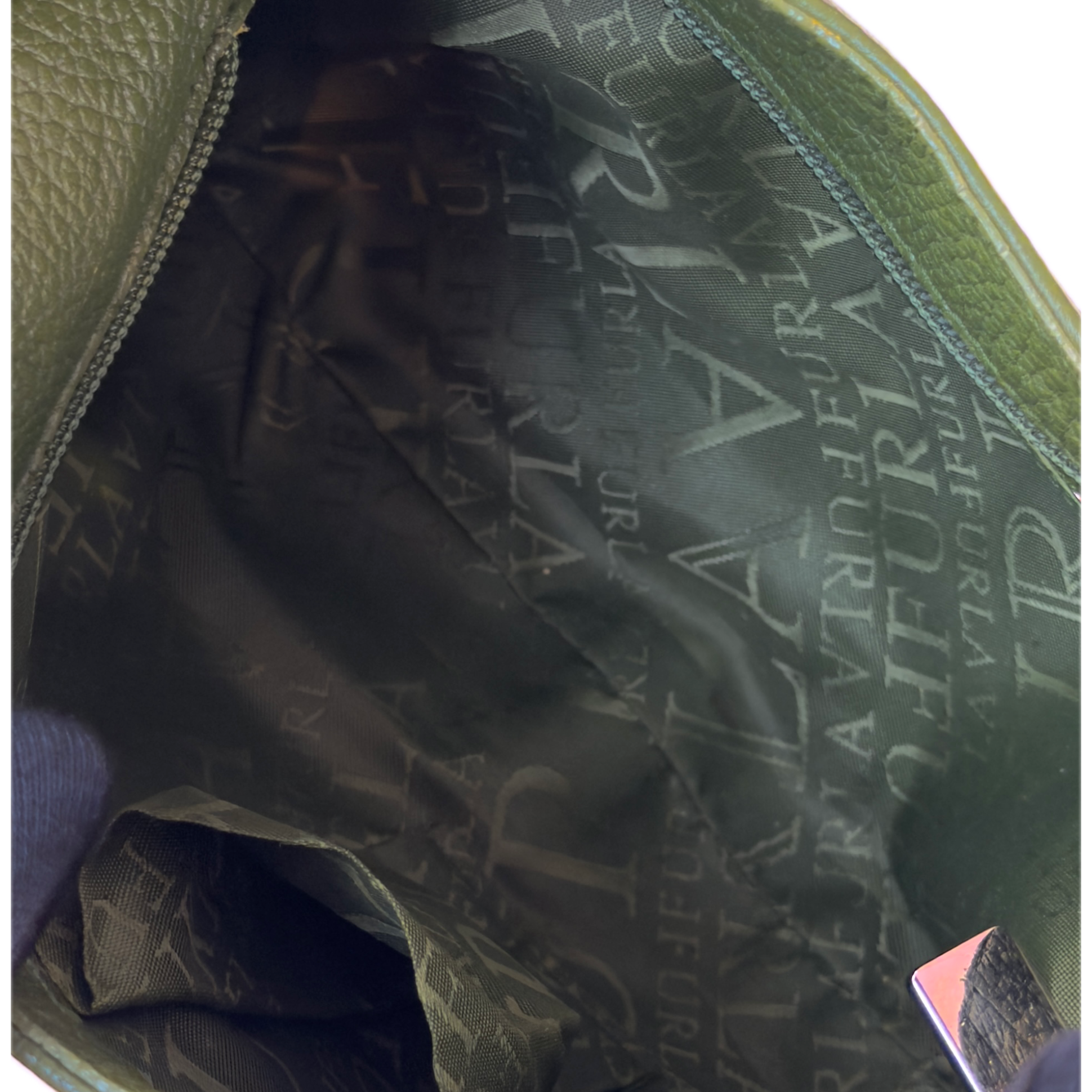 Vintage Furla forest green pebbled leather hobo bag featuring silver eyelet hardware and a structural shoulder strap.