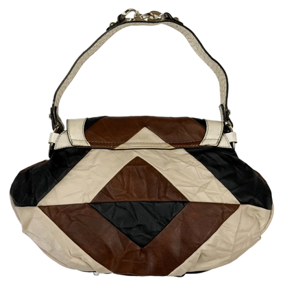 Vintage Guess slouchy hobo bag featuring a black, brown, and cream geometric pattern with a large silver G buckle closure.