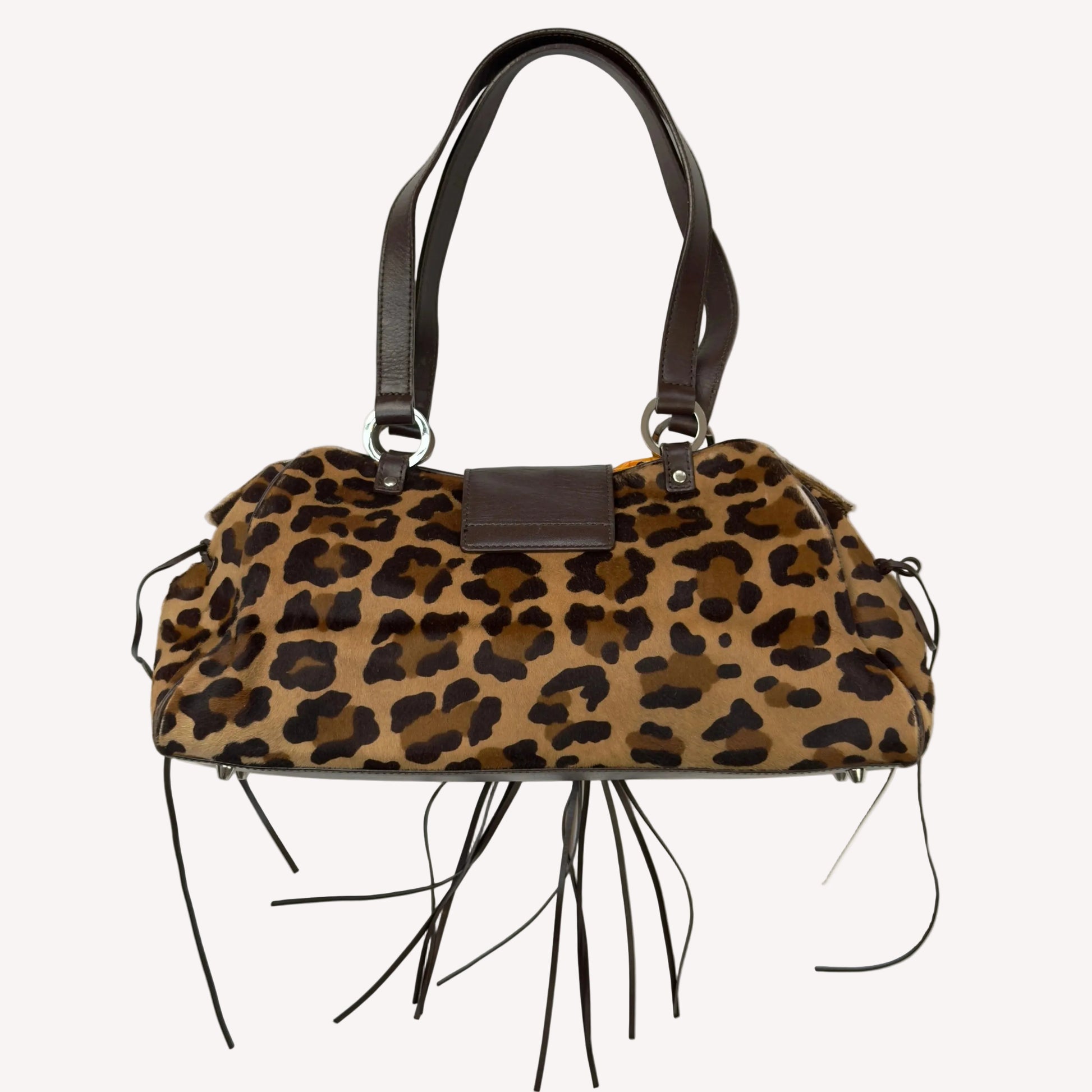 Vintage Karen Millen leopard print pony hair East-West shoulder bag featuring brown leather straps, silver hardware, and a leather fringe tassel.