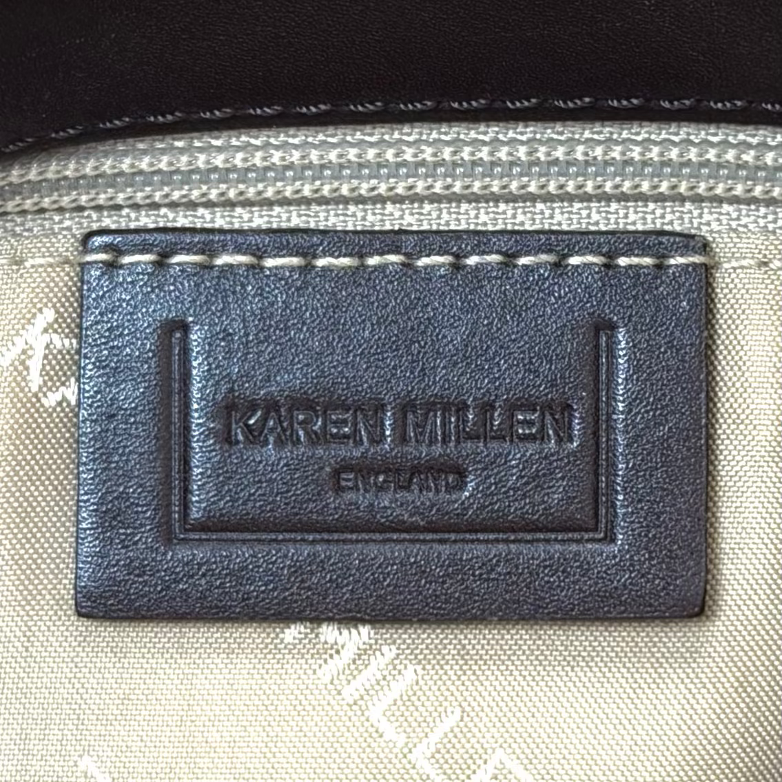 Vintage Karen Millen leopard print pony hair East-West shoulder bag featuring brown leather straps, silver hardware, and a leather fringe tassel.