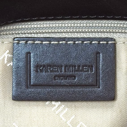 Vintage Karen Millen leopard print pony hair East-West shoulder bag featuring brown leather straps, silver hardware, and a leather fringe tassel.