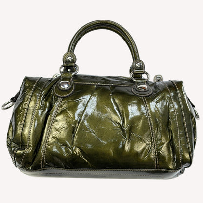 Deadstock vintage Y2K Kathy Van Zeeland metallic olive green crinkled faux patent leather bowler bag, featuring heavy silver buckle hardware, dual front pockets, and original tags.