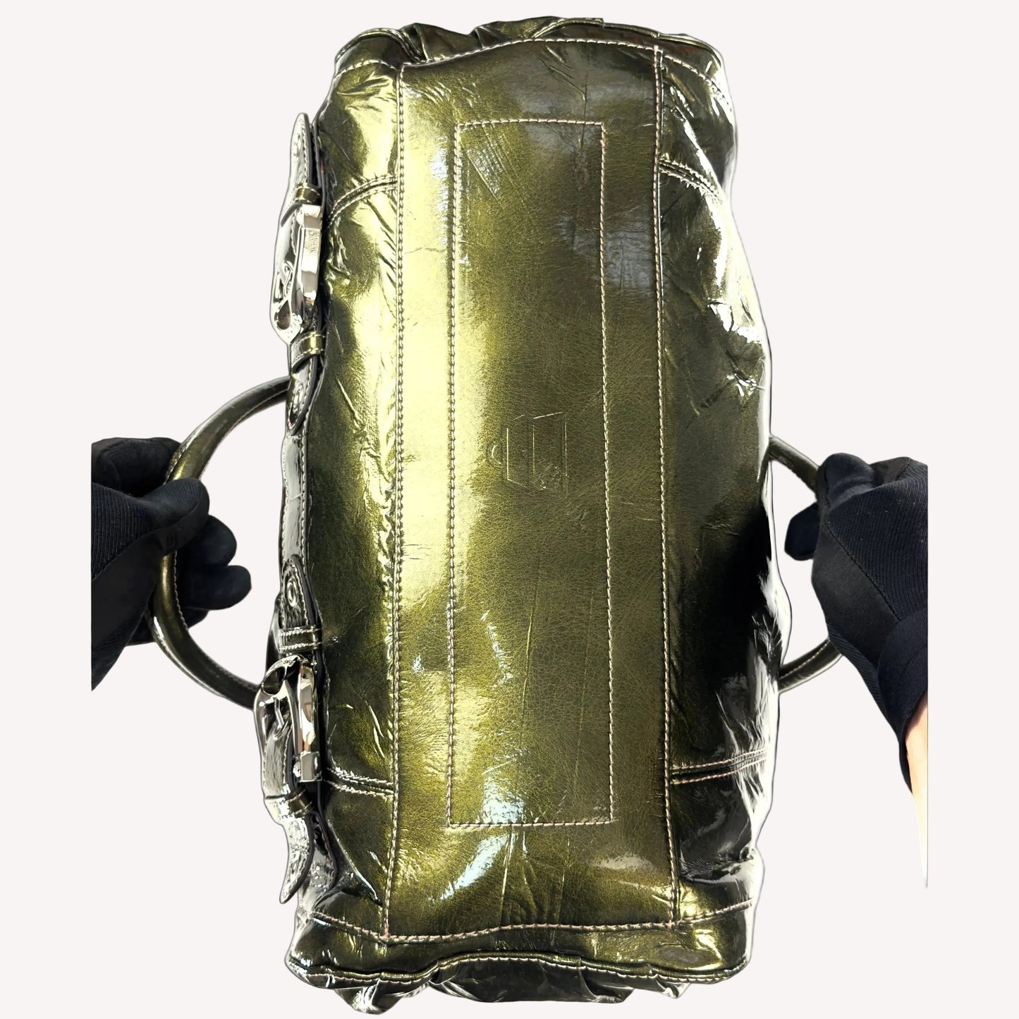 Deadstock vintage Y2K Kathy Van Zeeland metallic olive green crinkled faux patent leather bowler bag, featuring heavy silver buckle hardware, dual front pockets, and original tags.