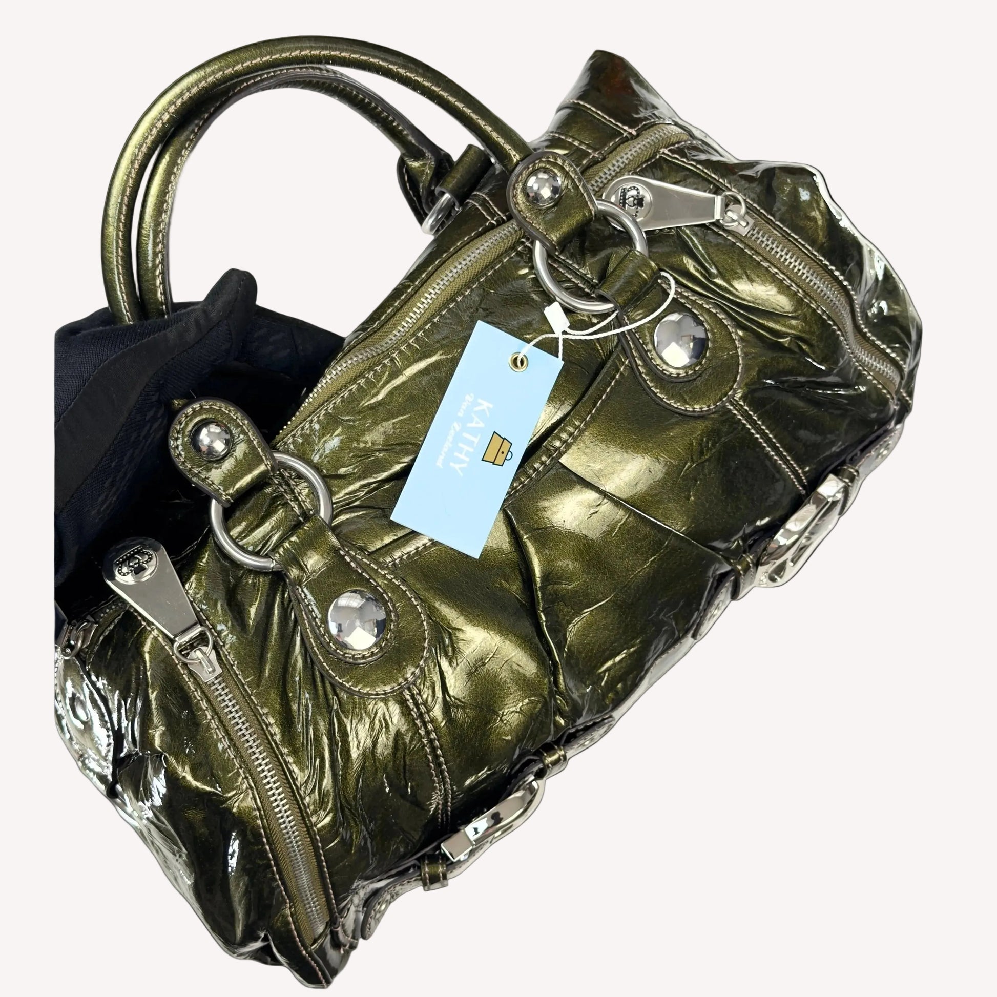 Heavy antique silver-tone buckle hardware and crown detailing on a vintage 2000s Kathy Van Zeeland McBling bag.