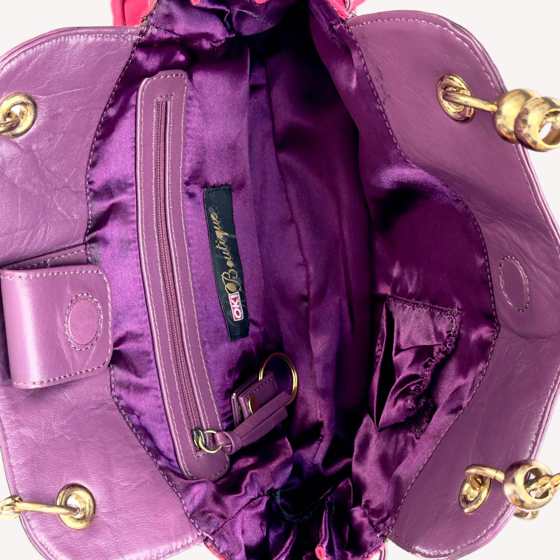 Vintage Y2K OK! Boutique shoulder bag in hot pink canvas and purple faux leather, featuring pink rhinestones, gold chain straps, and front pockets.