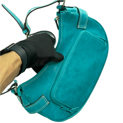 A vintage Y2K Rosetti blue crescent shoulder bag featuring a front buckle detail.
