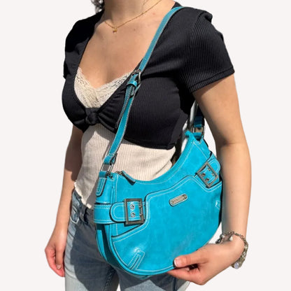 A vintage Y2K Rosetti blue crescent shoulder bag featuring a front buckle detail.