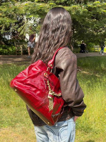 Person with a red handbag in a park setting