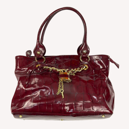 Vintage Russell & Bromley glossy red croc-embossed patent leather tote bag featuring gold chain and padlock hardware.