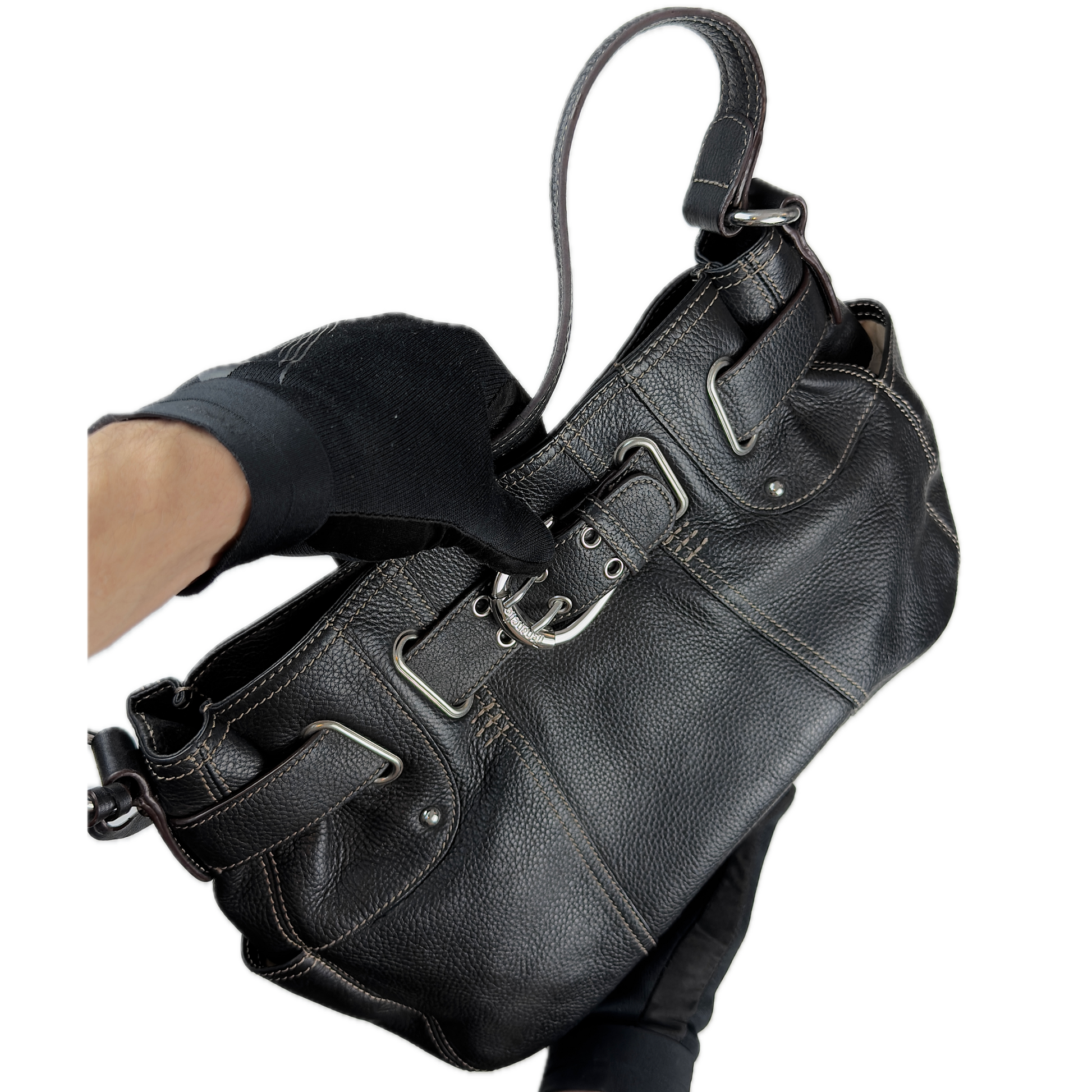 Vintage Tignanello black pebbled leather shoulder bag featuring a silver front buckle, contrast stitching, and side pockets.