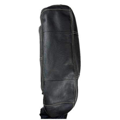 Vintage Tignanello black pebbled leather shoulder bag featuring a silver front buckle, contrast stitching, and side pockets.