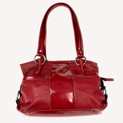 Vintage Y2K Tignanello cherry red pebbled leather shoulder bag featuring glossy patent trim, white contrast stitching, and a silver logo plaque.