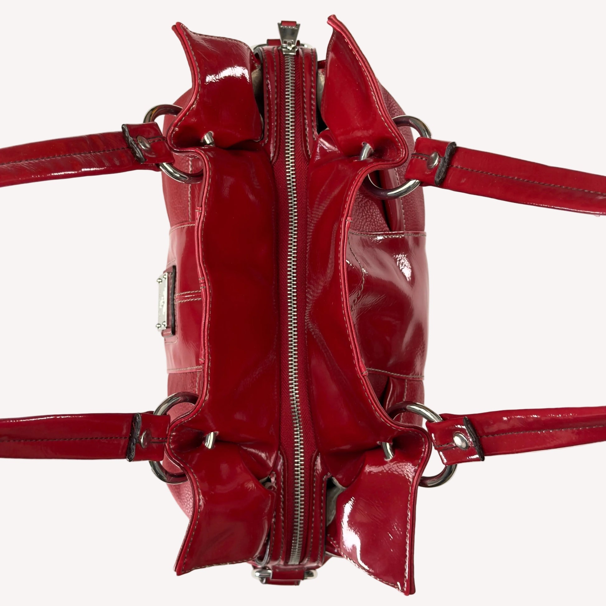 Vintage Y2K Tignanello cherry red pebbled leather shoulder bag featuring glossy patent trim, white contrast stitching, and a silver logo plaque.