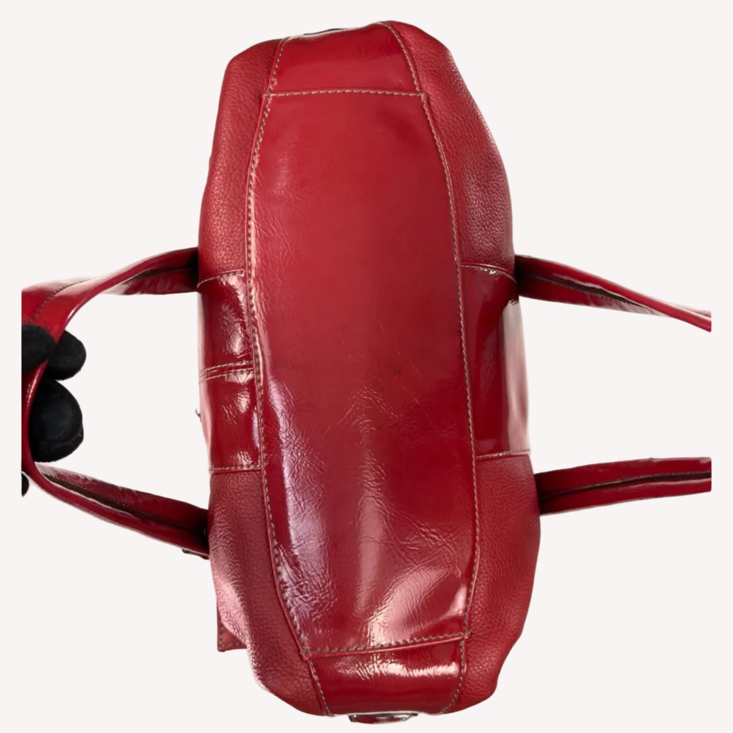 Vintage Y2K Tignanello cherry red pebbled leather shoulder bag featuring glossy patent trim, white contrast stitching, and a silver logo plaque.