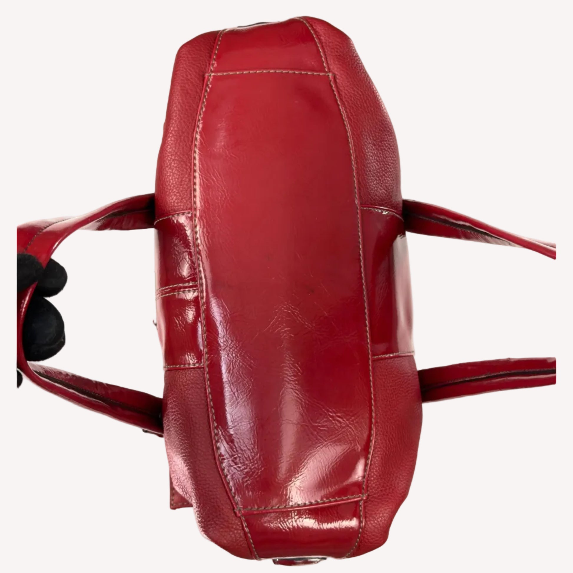 Vintage Y2K Tignanello cherry red pebbled leather shoulder bag featuring glossy patent trim, white contrast stitching, and a silver logo plaque.