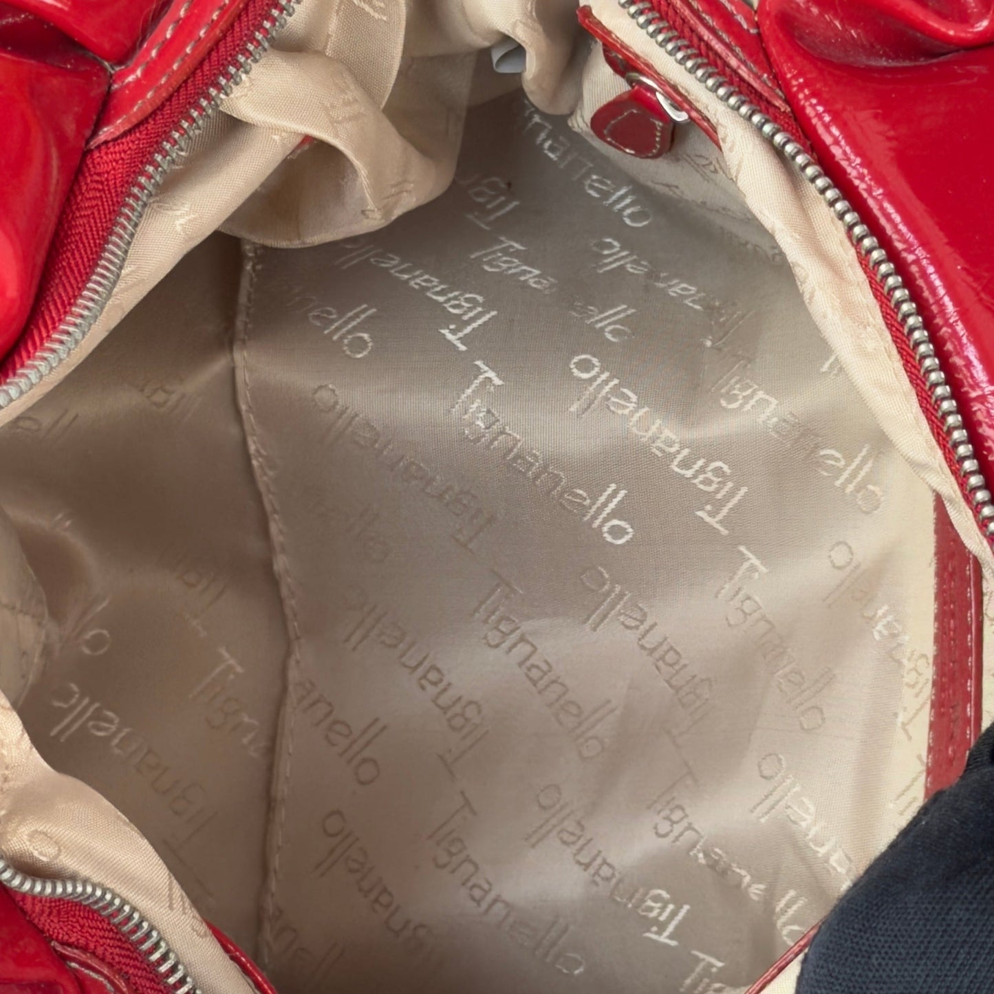 Vintage Y2K Tignanello cherry red pebbled leather shoulder bag featuring glossy patent trim, white contrast stitching, and a silver logo plaque.