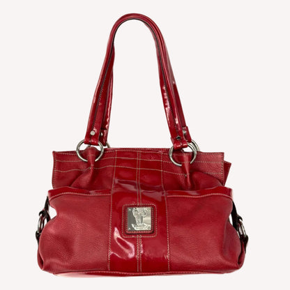 Vintage Y2K Tignanello cherry red pebbled leather shoulder bag featuring glossy patent trim, white contrast stitching, and a silver logo plaque.