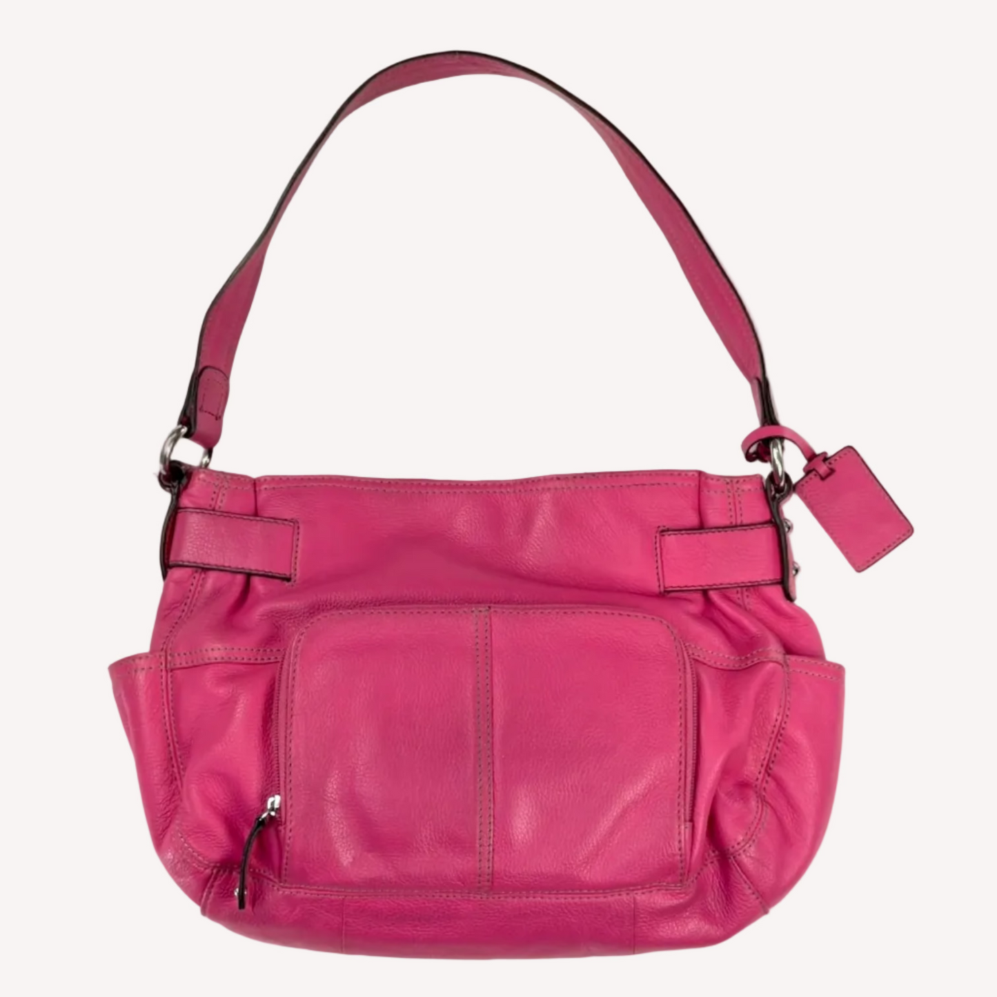 Vintage Y2K Tignanello hot pink pebbled leather shoulder bag featuring a statement silver front buckle, side slip pockets, and a branded metal hanging tag.