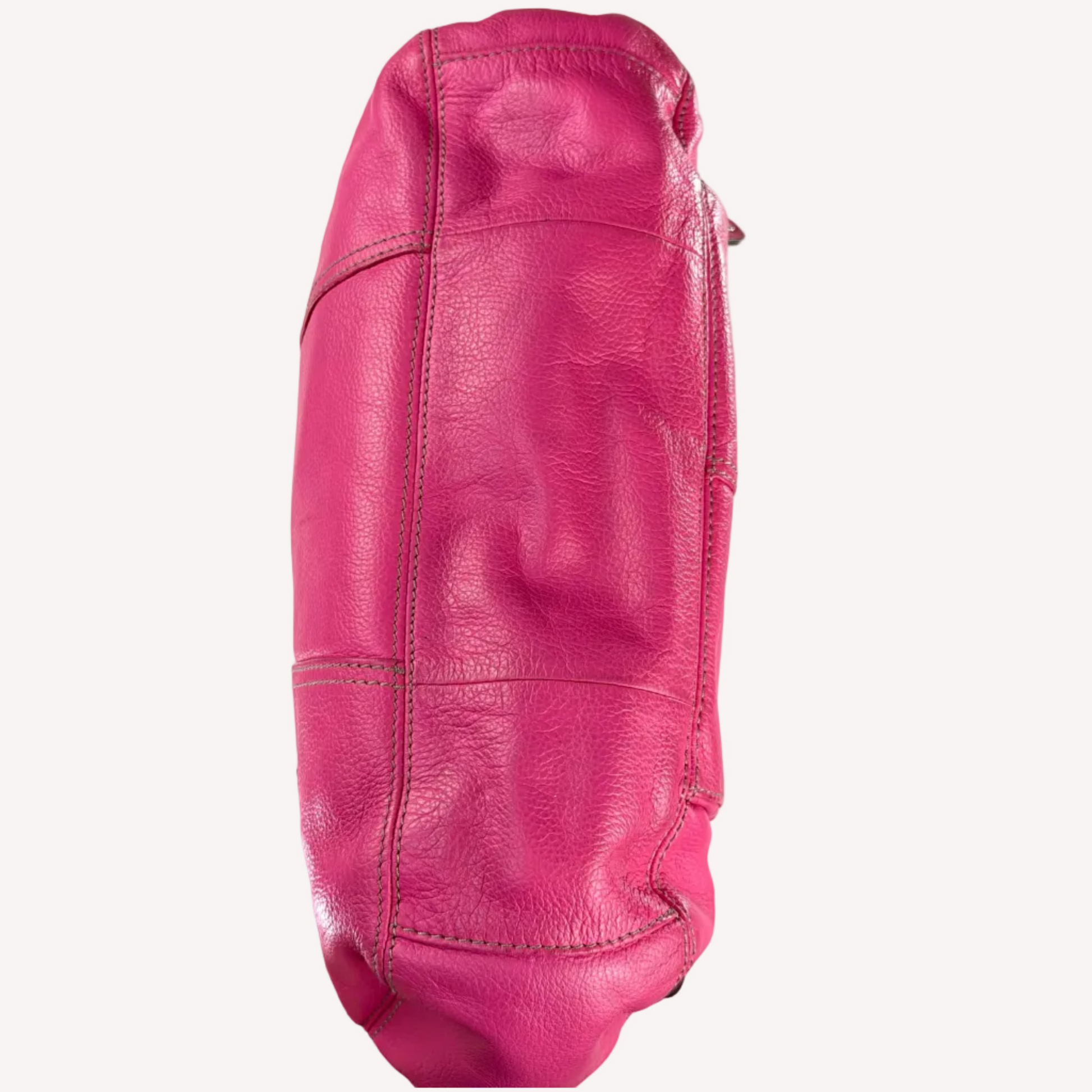 Vintage Y2K Tignanello hot pink pebbled leather shoulder bag featuring a statement silver front buckle, side slip pockets, and a branded metal hanging tag.