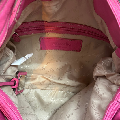 Vintage Y2K Tignanello hot pink pebbled leather shoulder bag featuring a statement silver front buckle, side slip pockets, and a branded metal hanging tag.