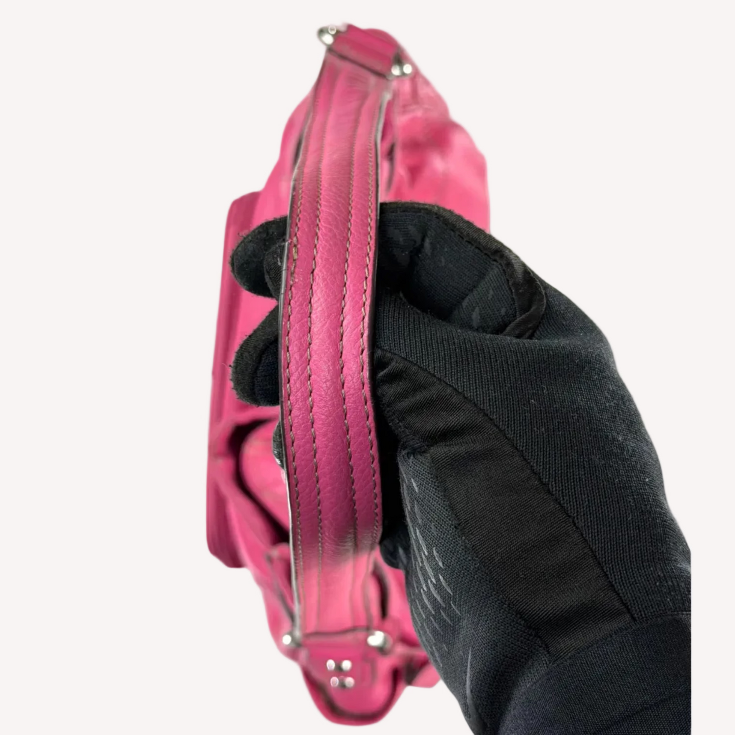Vintage Y2K Tignanello hot pink pebbled leather shoulder bag featuring a statement silver front buckle, side slip pockets, and a branded metal hanging tag.