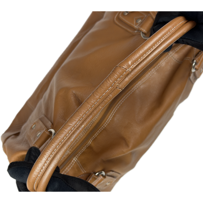 Vintage Tommy & Kate tan brown leather weekender travel bag featuring white contrast stitching, a lower shoe compartment, and a luggage tag.