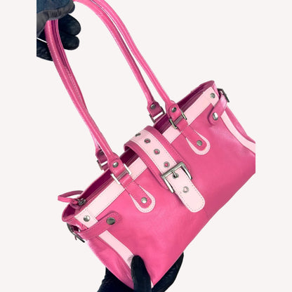 Vintage Y2K two-tone leather shoulder bag featuring a hot pink body, pale baby pink accents, and a silver front buckle.