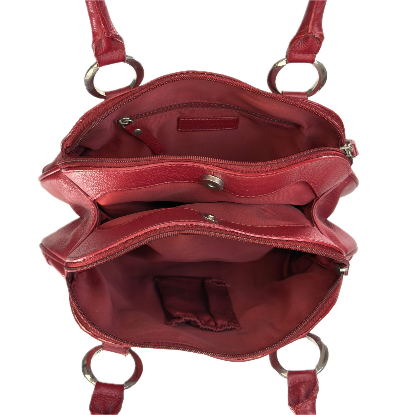 An open red leather handbag shown from above, revealing multiple interior compartments, zippered pockets, and silver-tone metal hardware including D-rings and a snap closure.