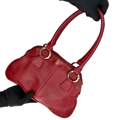 Front view of an elongated vintage Y2K Collection by Debenhams red genuine leather shoulder bag with silver hardware.