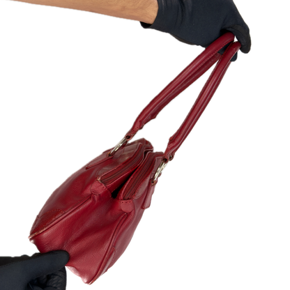 Side view of an elongated vintage Y2K Collection by Debenhams red genuine leather shoulder bag with silver hardware.