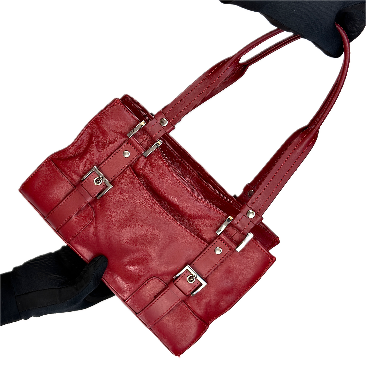 Front view of a structured vintage Y2K Collection by Debenhams glossy red shoulder bag featuring silver-tone buckle details against a black background.