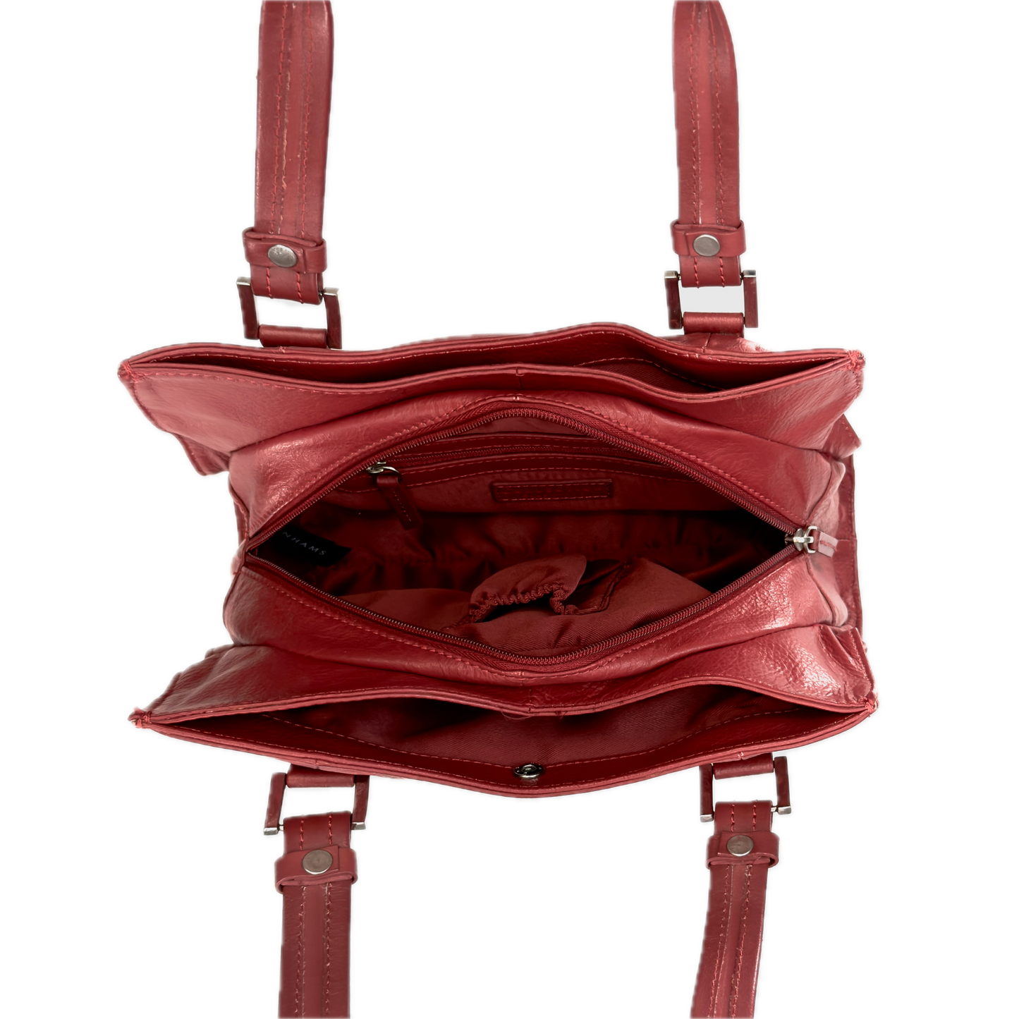 Top-down interior view of a vintage red shoulder bag showing three highly organised compartments and a clean red textile lining.