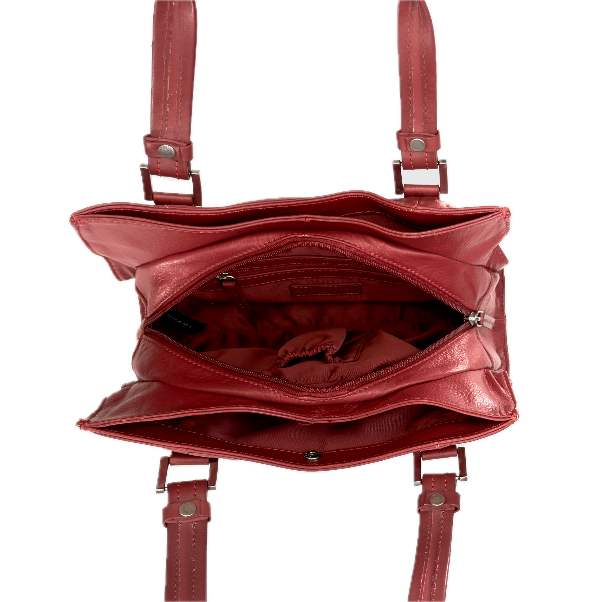 Top-down interior view of a vintage red shoulder bag showing three highly organised compartments and a clean red textile lining.
