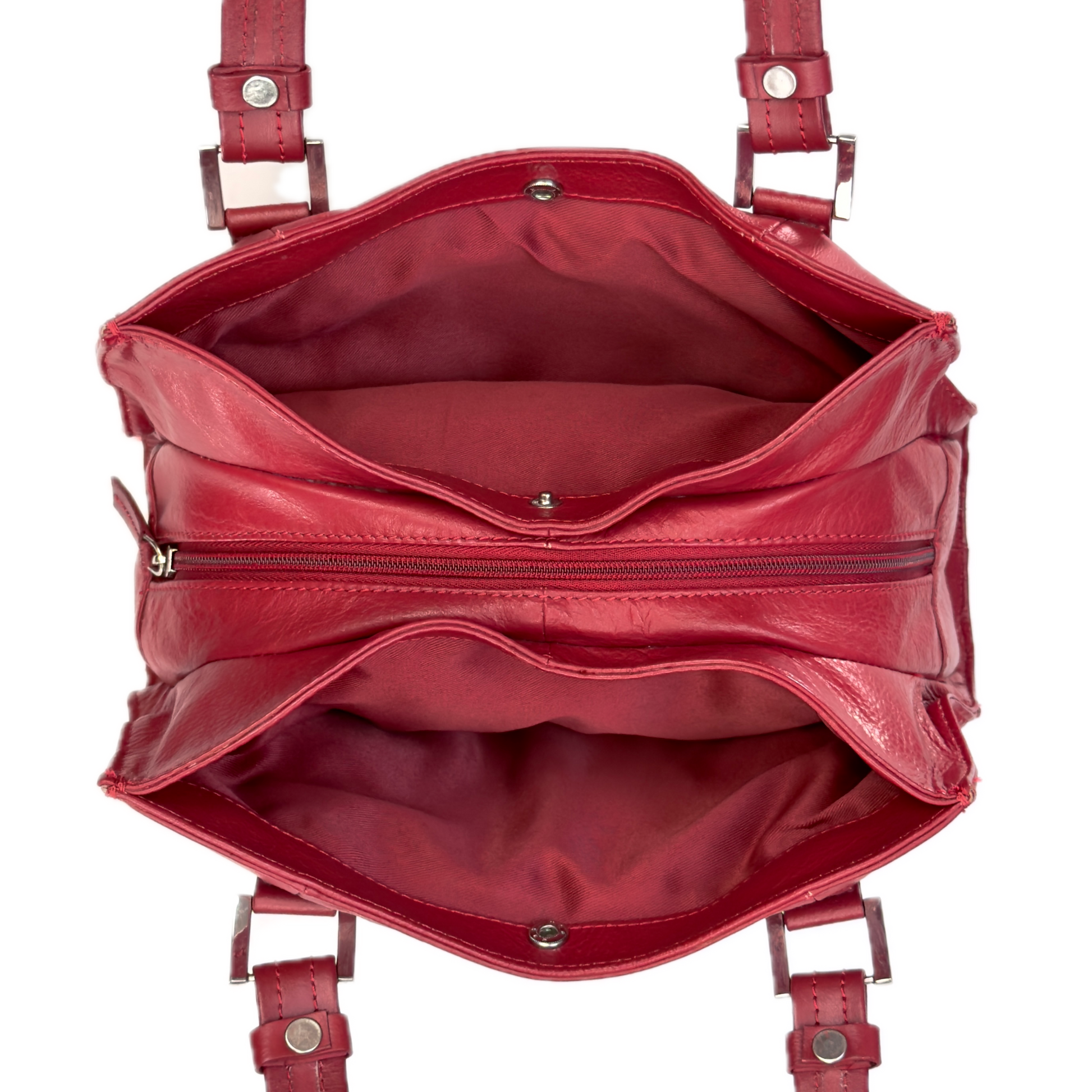 Top-down interior view of a vintage red shoulder bag showing three highly organised compartments and a clean red textile lining.