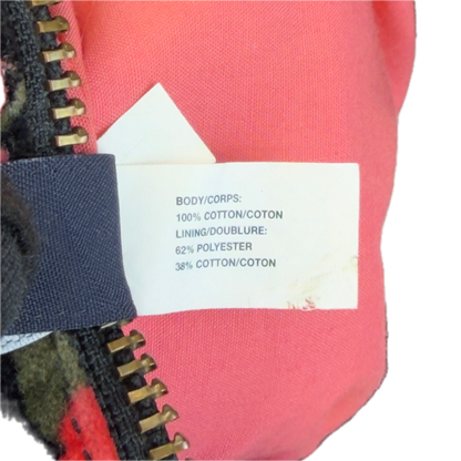 Close-up detail of the internal white garment tag on a vintage GAP velour bag, confirming its 100% cotton composition.