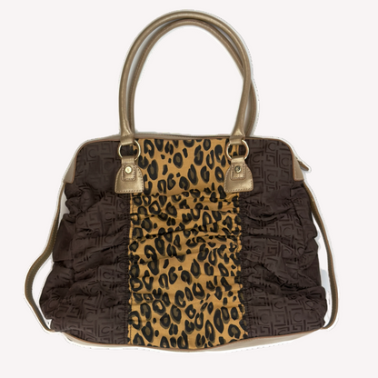 Reverse view of a vintage Y2K Liz Claiborne brown leopard animal print tote bag featuring tonal brown faux leather handles against a black background.