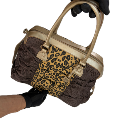 Front view of a vintage Y2K Liz Claiborne brown zebra animal print tote bag featuring tonal brown faux leather handles against a black background.