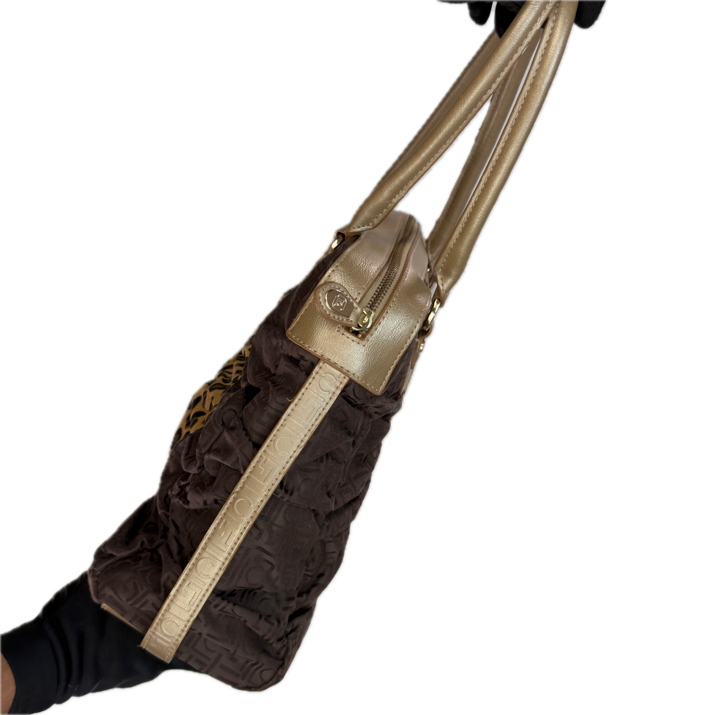 Side view of a vintage Y2K Liz Claiborne brown zebra animal print tote bag featuring tonal brown faux leather handles against a black background.