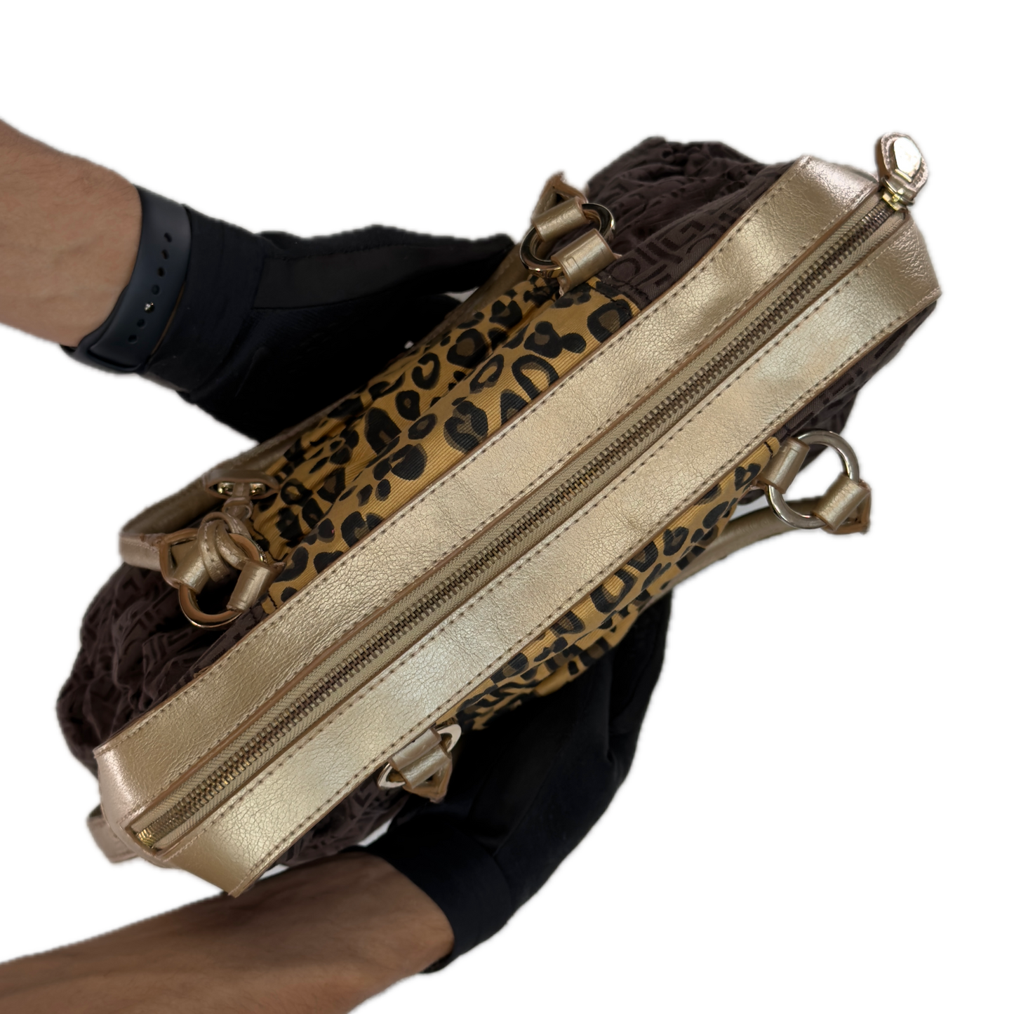 Close-up detail of the brown zebra print cotton blend fabric and faux leather trim on a vintage Liz Claiborne tote bag.