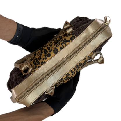 Close-up detail of the brown zebra print cotton blend fabric and faux leather trim on a vintage Liz Claiborne tote bag.